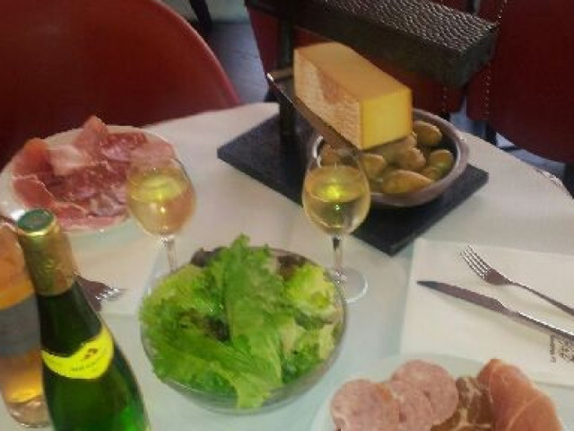 Assiette de charcuterie, fromage et salade verte avec verres de vin blanc